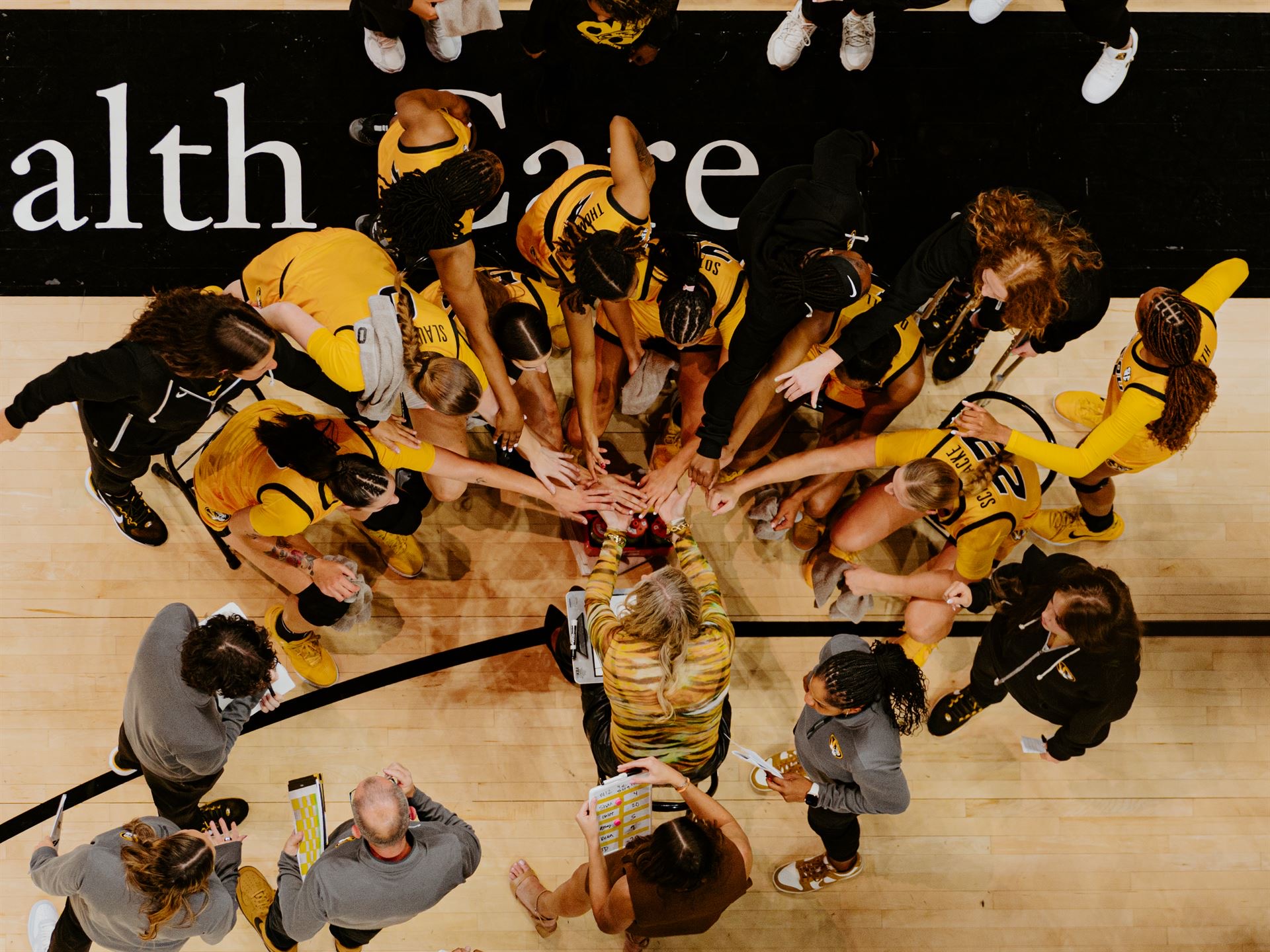 players putting their hands in a circle